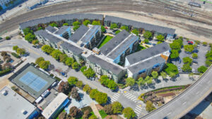 Aerial Exterior of crescent cove, courtyards in-between buildings, meticulous landscaping.
