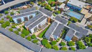 Aerial Exterior of crescent cove, courtyards in-between buildings, meticulous landscaping.